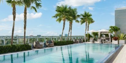 Relaxing pool area with sun chairs at The Altair Hotel Bay Harbor.