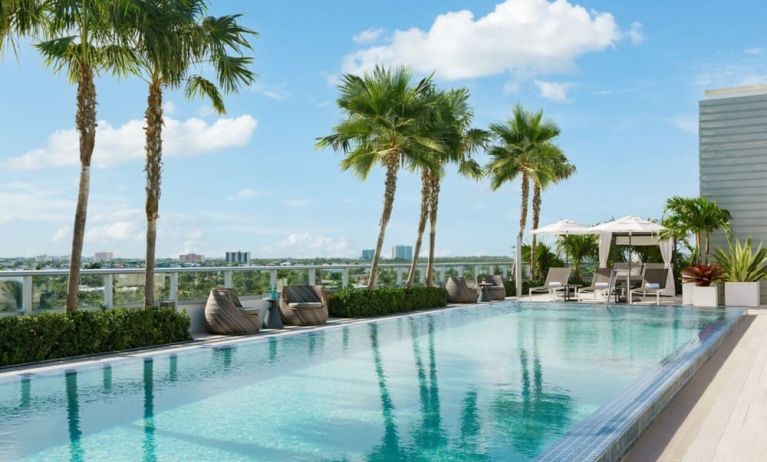 Relaxing pool area with sun chairs at The Altair Hotel Bay Harbor.