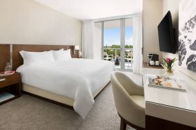 Spacious king bedroom with work desk at The Altair Hotel Bay Harbor.