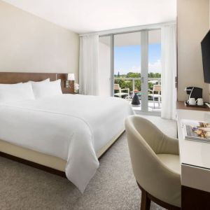 Spacious king bedroom with work desk at The Altair Hotel Bay Harbor.