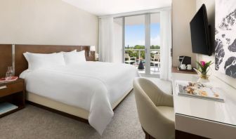 Spacious king bedroom with work desk at The Altair Hotel Bay Harbor.