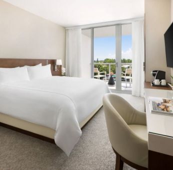 Spacious king bedroom with work desk at The Altair Hotel Bay Harbor.