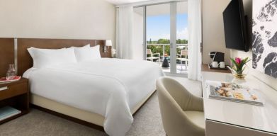 Spacious king bedroom with work desk at The Altair Hotel Bay Harbor.