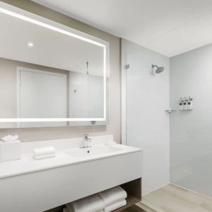 Private guest bathroom with shower at The Altair Hotel Bay Harbor.