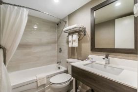 Private guest bathroom with shower and bath at Comfort Inn & Suites Barrie.