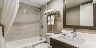 Private guest bathroom with shower and bath at Comfort Inn & Suites Barrie.