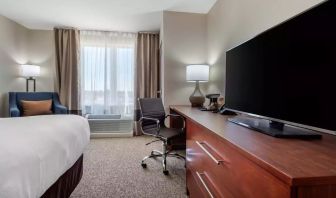 Delux king bed with TV and business desk at Comfort Inn & Suites Napanee.