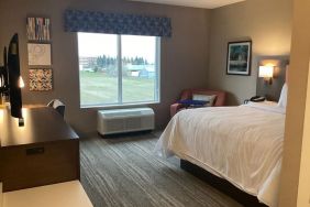 Spacious king bed with TV at Hampton Inn By Hilton Port Hope.