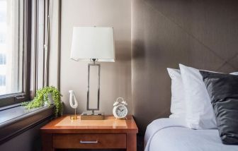 King bedroom with natural light at Magnolia Dallas.