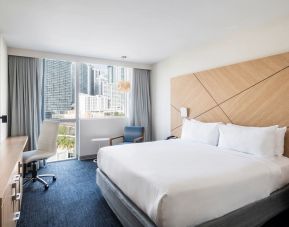 Spacious delux king bed with work desk at Novotel Miami Brickell.