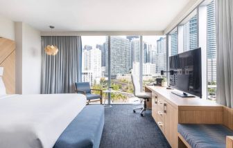 Spacious king bed with TV and work station at Novotel Miami Brickell.