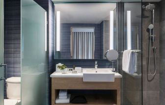 Private guest bathroom with shower at Novotel Miami Brickell.