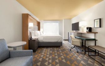 Spacious delux king with lounge, TV, and work station at Holiday Inn Houston Intercontinental Airport.