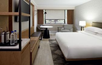 Delux king bed with TV at Sheraton Montreal Airport Hotel.