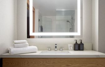 Guest bathroom with shower at Sheraton Montreal Airport Hotel.