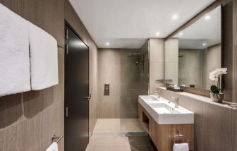 Private guest bathroom with shower at Vibe Hotel North Sydney.