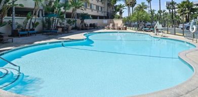 Stunning outdoor pool with pool chairs at Best Western San Diego Zoo/SeaWorld Inn & Suites.