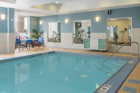 Large indoor pool with seating area at Holiday Inn Express North Bay.