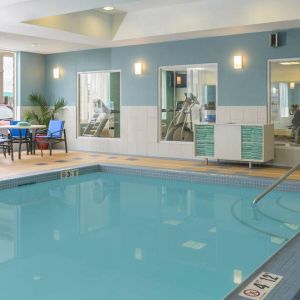 Large indoor pool with seating area at Holiday Inn Express North Bay.