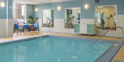 Large indoor pool with seating area at Holiday Inn Express North Bay.