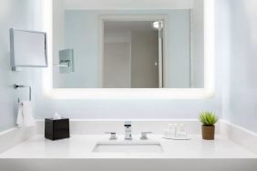 Well-lit guest bathroom with shower at Courtyard Boston Cambridge.