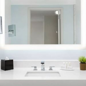 Well-lit guest bathroom with shower at Courtyard Boston Cambridge.