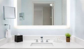 Well-lit guest bathroom with shower at Courtyard Boston Cambridge.