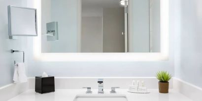 Well-lit guest bathroom with shower at Courtyard Boston Cambridge.