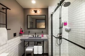 Private guest bathroom with shower at Moxy Boston Downtown.