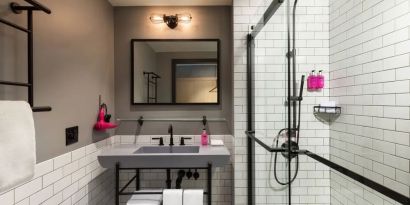 Private guest bathroom with shower at Moxy Boston Downtown.