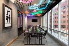 Professional and well-lit meeting room at Moxy Boston Downtown.