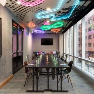 Professional and well-lit meeting room at Moxy Boston Downtown.