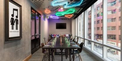 Professional and well-lit meeting room at Moxy Boston Downtown.