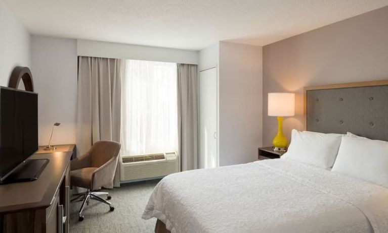 Delux king room with TV and work space at Hampton Inn Manhattan Chelsea.