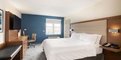 Delux king room with desk and TV at Holiday Inn Express & Suites Boston-Cambridge.