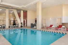 lovely indoor pool with surrounding seating area and sun beds at Homewood Suites by Hilton University City.