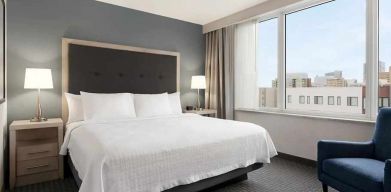 spacious king suite with work area and TV at Homewood Suites by Hilton University City.