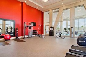 well equipped fitness center with natural light at Homewood Suites by Hilton University City.