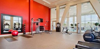 well equipped fitness center with natural light at Homewood Suites by Hilton University City.