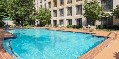 Stunning outdoor pool with seating area at DoubleTree Atlanta Airport.