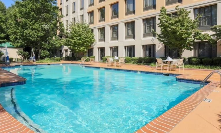 Stunning outdoor pool with seating area at DoubleTree Atlanta Airport.