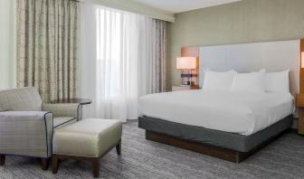 King bed with natural light at DoubleTree Atlanta Airport.