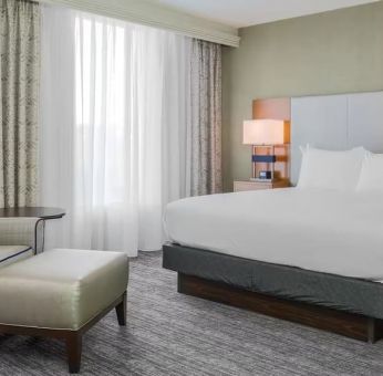 King bed with natural light at DoubleTree Atlanta Airport.