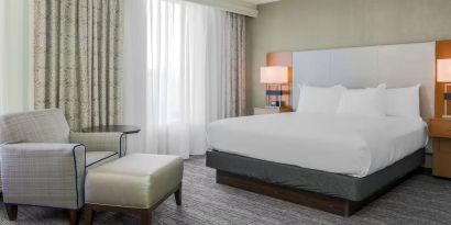 King bed with natural light at DoubleTree Atlanta Airport.