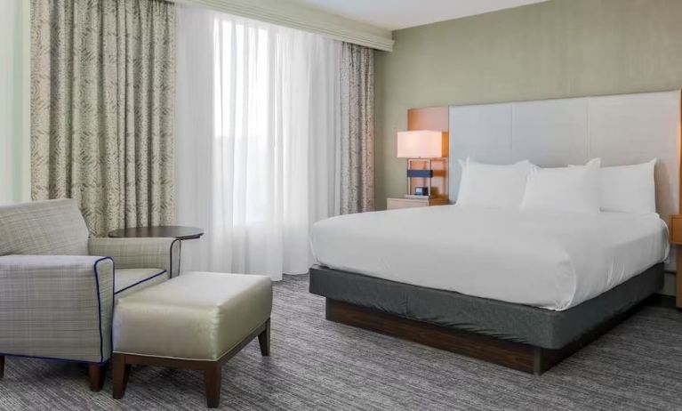 King bed with natural light at DoubleTree Atlanta Airport.