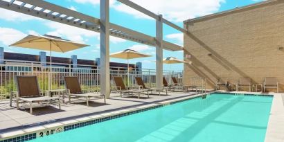 Lovely outdoor pool with pool chairs at Hilton Garden Inn Washington DC / Georgetown Area.