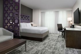 King bedroom with TV and business desk at Courtyard San Diego Downtown.