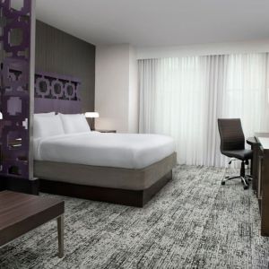 King bedroom with TV and business desk at Courtyard San Diego Downtown.