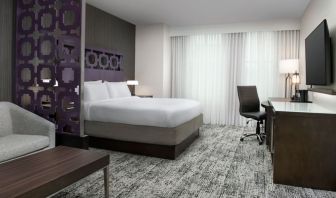 King bedroom with TV and business desk at Courtyard San Diego Downtown.