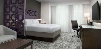 King bedroom with TV and business desk at Courtyard San Diego Downtown.